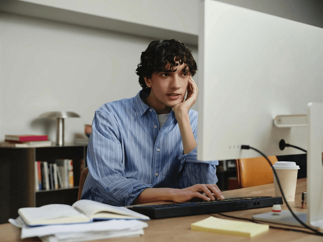 Agency professional at desk — client management and AI workflow