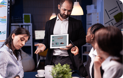 Team discussion with tablet and charts